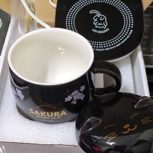 Sakura Black Cup with Gold Text and White Floral Accents